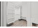 Spacious walk-in closet with custom white shelves and storage at 292 Sunlit Cove Ne Dr, St Petersburg, FL 33702