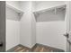 Walk-in closet features wood floors, gray trim, and white shelving at 292 Sunlit Cove Ne Dr, St Petersburg, FL 33702