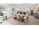 Bright dining room featuring modern light fixtures, decorative wall art, and a stylish wooden dining table with seating for six at 292 Sunlit Cove Ne Dr, St Petersburg, FL 33702