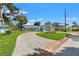 Charming home with a circular driveway, lush landscaping, and attached garage at 292 Sunlit Cove Ne Dr, St Petersburg, FL 33702