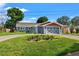 Charming blue home with a well-maintained lawn and a beautifully designed garage door at 292 Sunlit Cove Ne Dr, St Petersburg, FL 33702