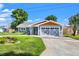 Inviting home with neat landscaping, a well-maintained lawn, and a spacious driveway at 292 Sunlit Cove Ne Dr, St Petersburg, FL 33702
