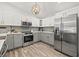 Bright kitchen features stainless steel appliances, two-tone cabinets and stylish wood-look floors at 292 Sunlit Cove Ne Dr, St Petersburg, FL 33702