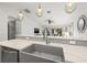 Close-up of a modern kitchen sink with stylish fixtures and a view into the open-concept living space at 292 Sunlit Cove Ne Dr, St Petersburg, FL 33702