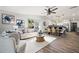Open floor plan living room flows to the dining room and kitchen areas of the home at 292 Sunlit Cove Ne Dr, St Petersburg, FL 33702