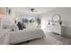 Bright main bedroom with sliding doors to the canal, light furniture, and modern decor at 292 Sunlit Cove Ne Dr, St Petersburg, FL 33702