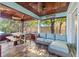 Inviting covered patio features a dining area and comfortable seating, perfect for outdoor relaxation and entertaining at 292 Sunlit Cove Ne Dr, St Petersburg, FL 33702