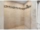 Shower with a tiled wall and floor and modern showerhead at 292 Sunlit Cove Ne Dr, St Petersburg, FL 33702