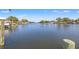 Expansive waterfront view from the dock, showcasing the peaceful river and surrounding natural beauty at 292 Sunlit Cove Ne Dr, St Petersburg, FL 33702