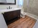 Modern bathroom featuring a vanity, glass shower, and wood-look flooring at 3122 Egret Ter, Safety Harbor, FL 34695