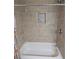 Tiled bathtub and shower with built-in niche offer a relaxing and modern bathing experience at 3122 Egret Ter, Safety Harbor, FL 34695