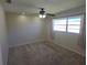 Comfortable carpeted bedroom featuring a ceiling fan, window, and neutral decor at 3122 Egret Ter, Safety Harbor, FL 34695