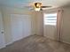 Comfortable carpeted bedroom featuring a ceiling fan, window, and closet for ample storage at 3122 Egret Ter, Safety Harbor, FL 34695