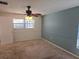 Cozy bedroom with carpet flooring, ceiling fan, and a painted accent wall at 3122 Egret Ter, Safety Harbor, FL 34695