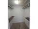 Walk-in closet with built-in shelving, providing ample storage space at 3122 Egret Ter, Safety Harbor, FL 34695