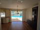 Bright dining area featuring wood flooring and sliding glass doors leading to the pool at 3122 Egret Ter, Safety Harbor, FL 34695