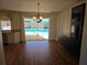 Dining area featuring wood flooring and sliding glass doors leading to the pool at 3122 Egret Ter, Safety Harbor, FL 34695