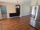 Inviting dining area featuring wood flooring, modern built-in cabinets, and stainless steel refrigerator at 3122 Egret Ter, Safety Harbor, FL 34695