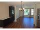 Bright dining area with wood floors, chandelier, and a view of the front yard at 3122 Egret Ter, Safety Harbor, FL 34695