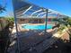 A covered pool and brick patio are framed by a screened-in porch at 3122 Egret Ter, Safety Harbor, FL 34695