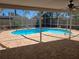 A covered patio with a ceiling fan overlooks the kidney shaped pool at 3122 Egret Ter, Safety Harbor, FL 34695