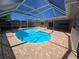 The covered pool is kidney shaped and surrounded by a brick patio at 3122 Egret Ter, Safety Harbor, FL 34695