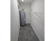 A utility room featuring gray patterned flooring and a gray water heater at 3122 Egret Ter, Safety Harbor, FL 34695