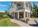 Inviting backyard with covered patio seating, lush landscaping, and manicured lawn at 315 64Th St, Holmes Beach, FL 34217