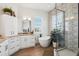 Bathroom features wood flooring, a soaking tub, a glass enclosed shower, and plenty of storage at 315 64Th St, Holmes Beach, FL 34217