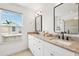 Elegant bathroom features double sinks, granite countertops, and black framed mirrors for a modern touch at 315 64Th St, Holmes Beach, FL 34217