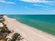 Expansive beach view with turquoise ocean water under a partly cloudy blue sky at 315 64Th St, Holmes Beach, FL 34217