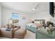 The bedroom features a fan, large windows, and sitting area with an ottoman at 315 64Th St, Holmes Beach, FL 34217