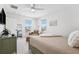 Cozy bedroom featuring a comfortable bed, a chaise lounge, and ample natural light from the surrounding windows at 315 64Th St, Holmes Beach, FL 34217