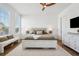 Bedroom features a ceiling fan, horizontal plank accent wall, and natural light from the windows at 315 64Th St, Holmes Beach, FL 34217