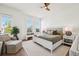 This bedroom has a padded headboard, neutral colors, and an abundance of natural light from the large windows at 315 64Th St, Holmes Beach, FL 34217