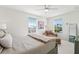 Bright bedroom with a plush chaise lounge, ceiling fan, and large windows offering plenty of natural light at 315 64Th St, Holmes Beach, FL 34217
