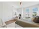 Well-lit bedroom features horizontal plank accent wall, wood floors, and a sitting area by the window at 315 64Th St, Holmes Beach, FL 34217