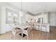 Airy dining area featuring a modern light fixture, stylish table setting, and wood look tile flooring at 315 64Th St, Holmes Beach, FL 34217