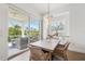 Bright dining room features wood chairs and sliding glass door to covered porch at 315 64Th St, Holmes Beach, FL 34217