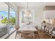Bright dining room with sliding glass doors to a deck and backyard pool views at 315 64Th St, Holmes Beach, FL 34217