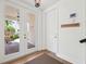 Bright entryway with wood accents, a coat rack, and view of the front yard at 315 64Th St, Holmes Beach, FL 34217