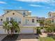 Beautiful two-story yellow condo with a private balcony and attached garage in a sunny neighborhood at 315 64Th St, Holmes Beach, FL 34217