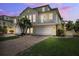 Charming two-story home with brick driveway, white garage doors and a balcony at 315 64Th St, Holmes Beach, FL 34217