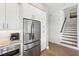 Updated kitchen with stainless steel refrigerator and appliances plus modern finishes and wood look flooring at 315 64Th St, Holmes Beach, FL 34217