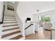 Inviting living room featuring stairs, white furniture, light wood flooring, and bright, natural light at 315 64Th St, Holmes Beach, FL 34217