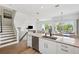 Open concept living space with a kitchen island, stairs, and a living room with lots of natural light at 315 64Th St, Holmes Beach, FL 34217