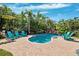 Private backyard pool surrounded by lush landscaping and comfortable lounge chairs at 315 64Th St, Holmes Beach, FL 34217