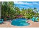 Secluded pool area surrounded by lush tropical landscaping and comfortable Adirondack chairs at 315 64Th St, Holmes Beach, FL 34217