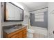 Bathroom with updated vanity, mirror, lighting and shower over tub at 3256 Roxborough Ave, Clearwater, FL 33762