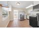 Kitchen with stainless steel fridge, ample countertop space, and tile flooring extending to dining area at 3256 Roxborough Ave, Clearwater, FL 33762